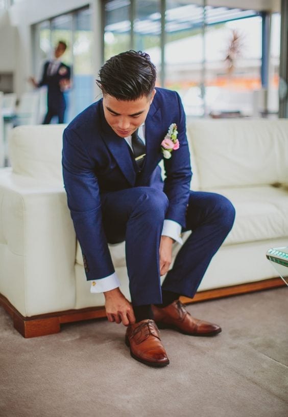 blue suit with brown dress shoes