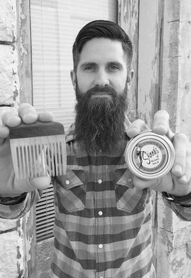 bearded man with wooden beard comb
