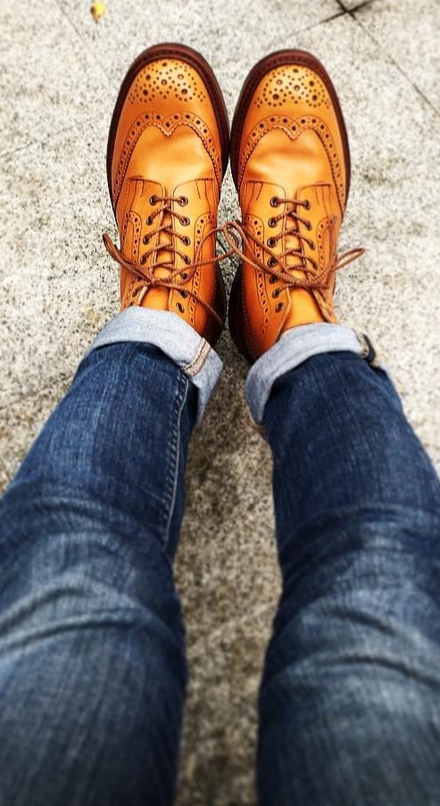 Brown winged brogues with blue denims for men