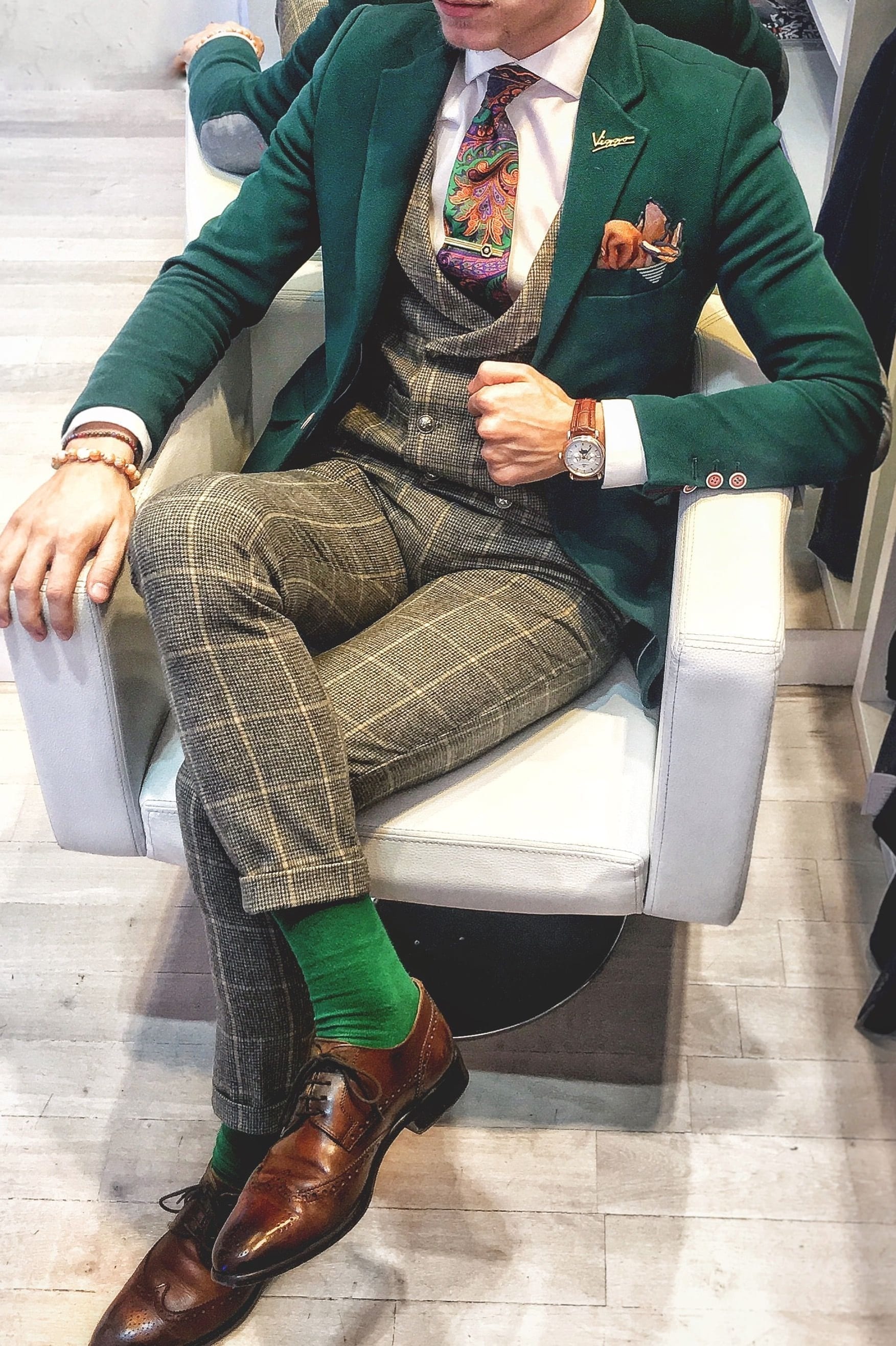 Green suit with funky tie,socks,lapel and pocket square
