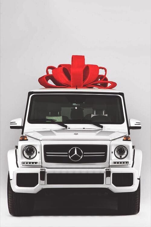 White Mercedes G Wagon with a red bow