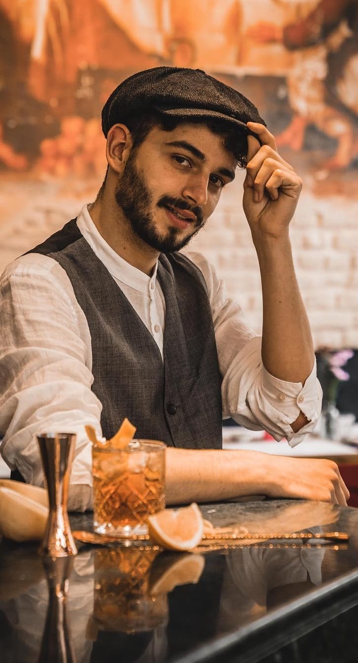 White shirt waistcoat and cap