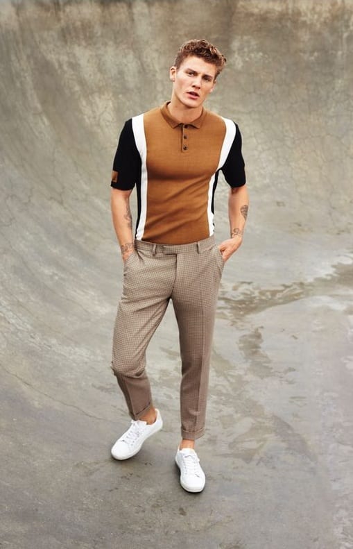 Men's spring summer outfit with black plain glasses, orange plain polo shirt,  blue plain denim/jeans, white low-cut sneakers. | OTOKOMAE