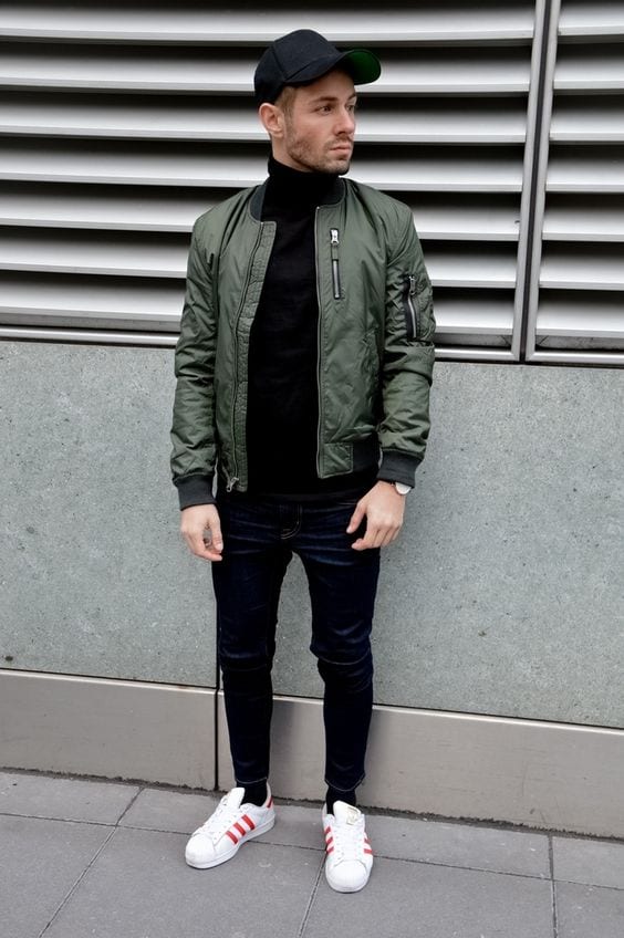 Green-Bomber-Jacket-styled-with-Black-Sweater-Denim-Jeans-and-round-off-this-look-by-wearing-White-Sneakers-1