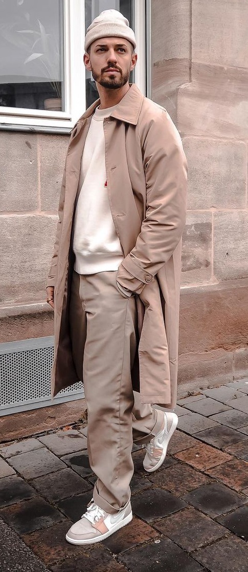Neutral color tones for winter with a sweater layered with topcoat and styled with beanie and sneakers