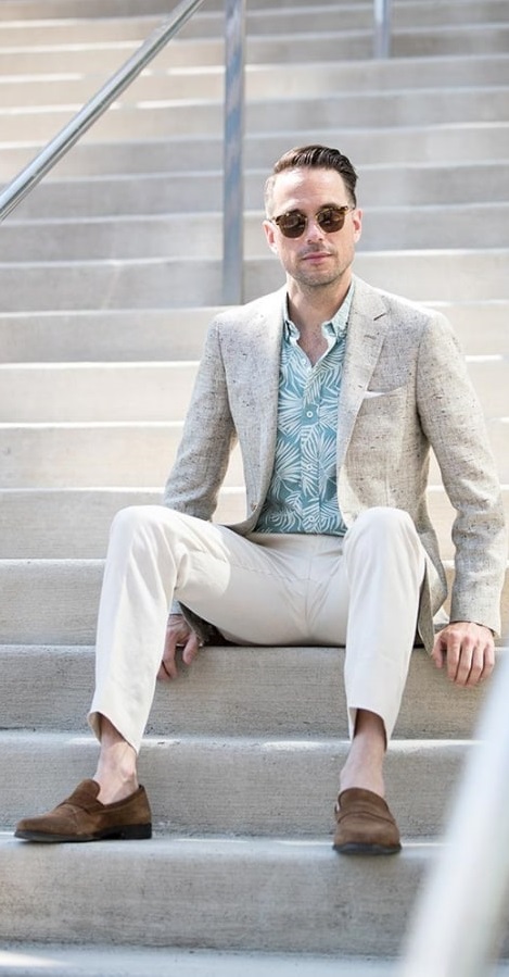 A blue printed shirt paired under a grey coat white pants & brown shoes - Printed Shirt Combinationss for Men
