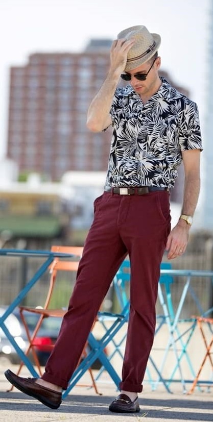 Black & White printed Shirt paired red pants & dark brown shoes styled with a leather belt & beige color hat - Printed Shirt Combinationss for Men