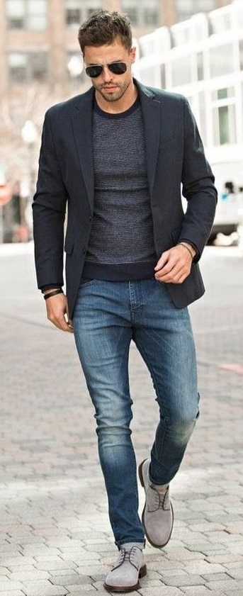 Dark grey tshirt with a darker tone of grey colored suit Wearing a blue denim. Accessorized with shades and light grey shoes_