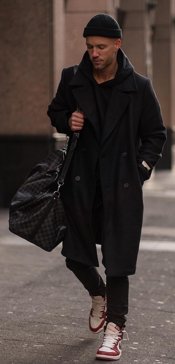 A long overcoat with trousers and shoes with a bag