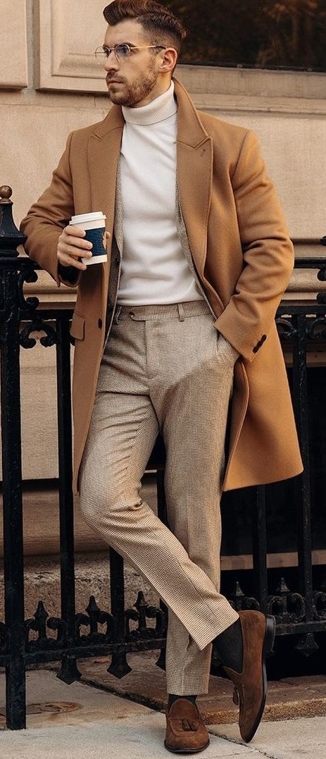 Cream turtle neck t-shirt with dark beige long overcoat and a lighter shade of beige trousers_