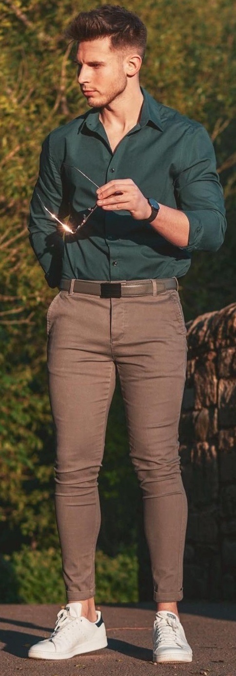 Green shirt with brown trousers and a belt, accessorized with shades_