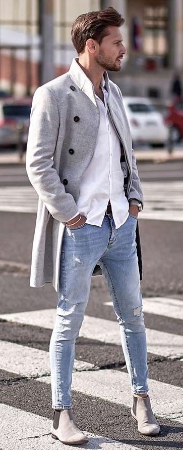 Long over coat with white shirt wearing slightly ripped jeans and grey boots