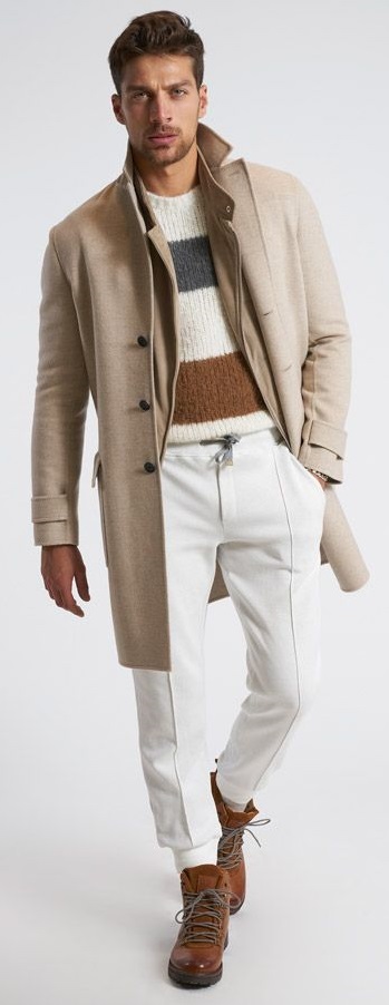 beige overcoat with white chinos and sweater inside with long lace up shoe