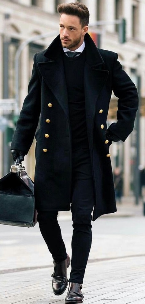 black overcoat with white undershirt and a tie, wearing a shoe and holding a bag in hand