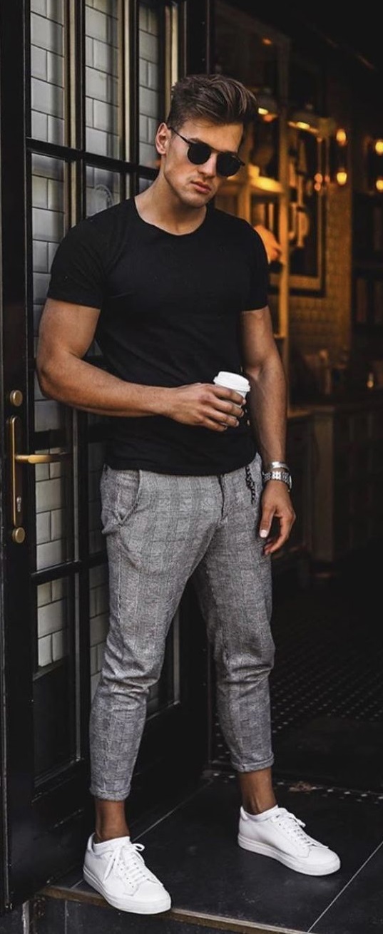 black t-shirt and grey checked chinos wearing shades, watch and white sneakers_