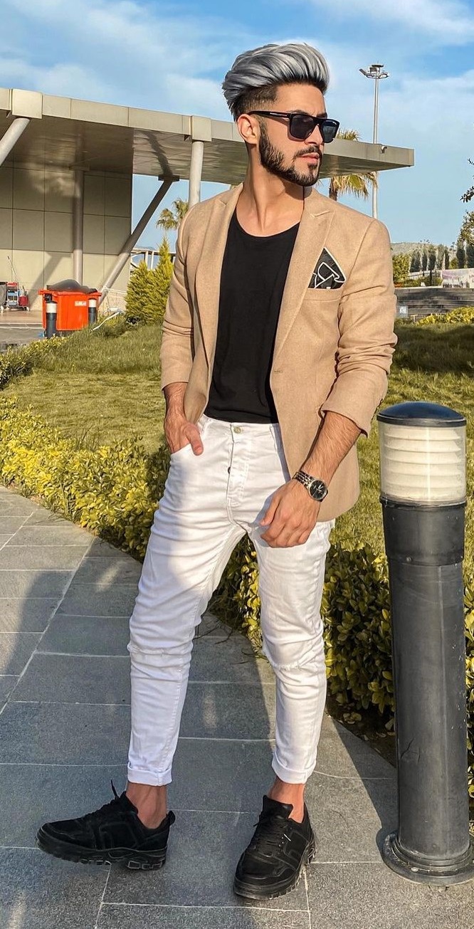 black t shirt with beige suit and white chinos and black boots accessorized with shades and pocket square