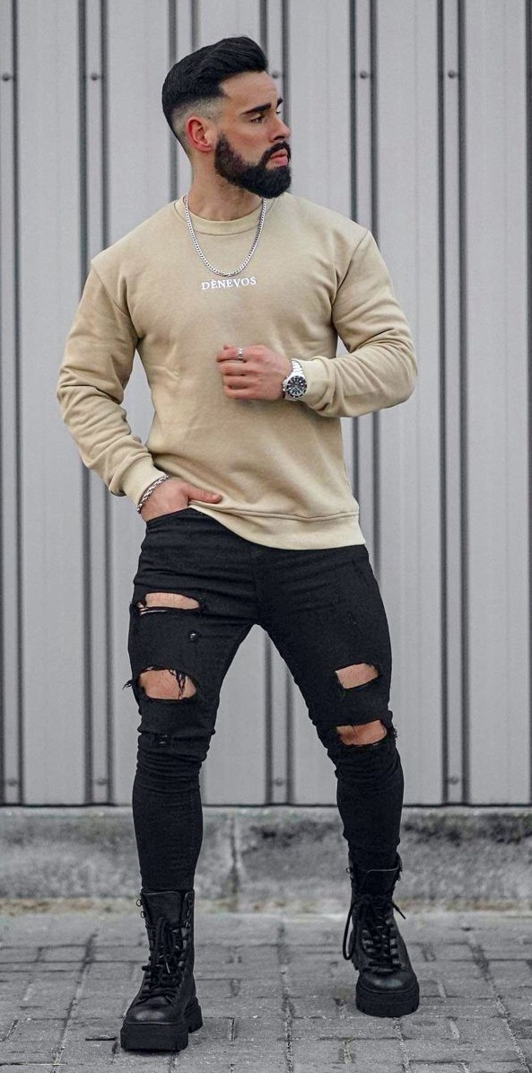 ripped black denims with beige t-shirt accessorized with a watch and laced shoes_