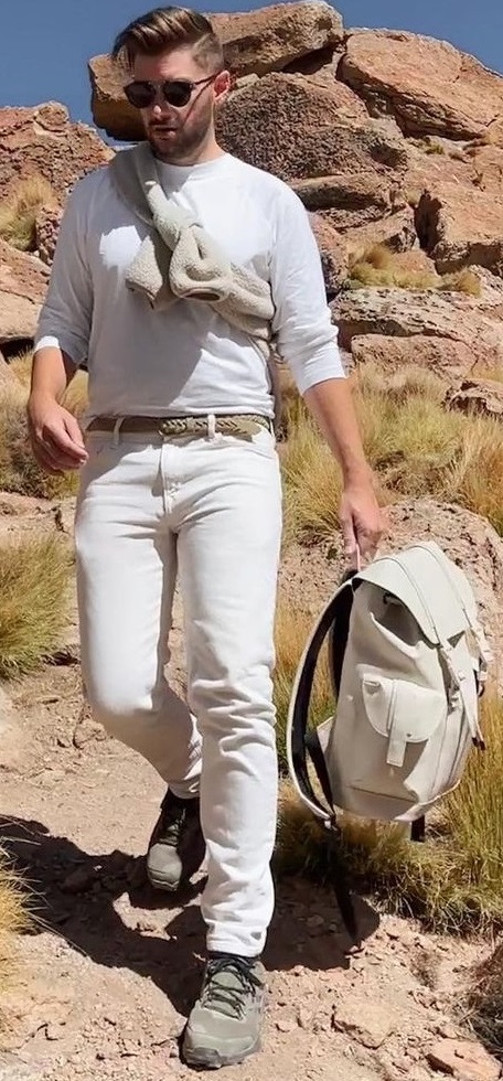 t-shirt with chinos carrying a bag in hand with brown belt
