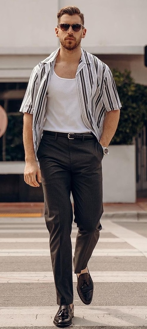 vested t-shirt with a open buttoned shirt and trousers with boots