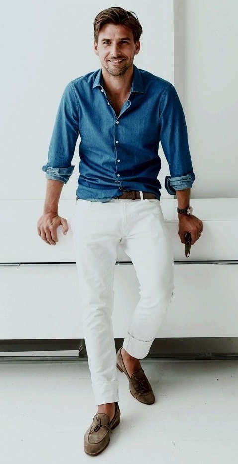 white chinos with blue shirt accessorized with belt and a watch and boots