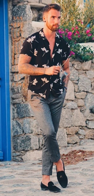 Black shirt with white flower paired with grey chinos and suede