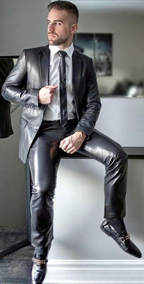 Grey shiny suit with same colored tie and formal shoes