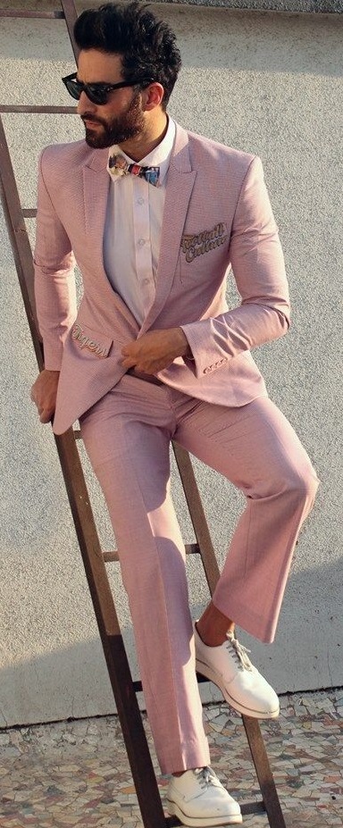 Pink suit with white shirt and bow tie and white sneakers