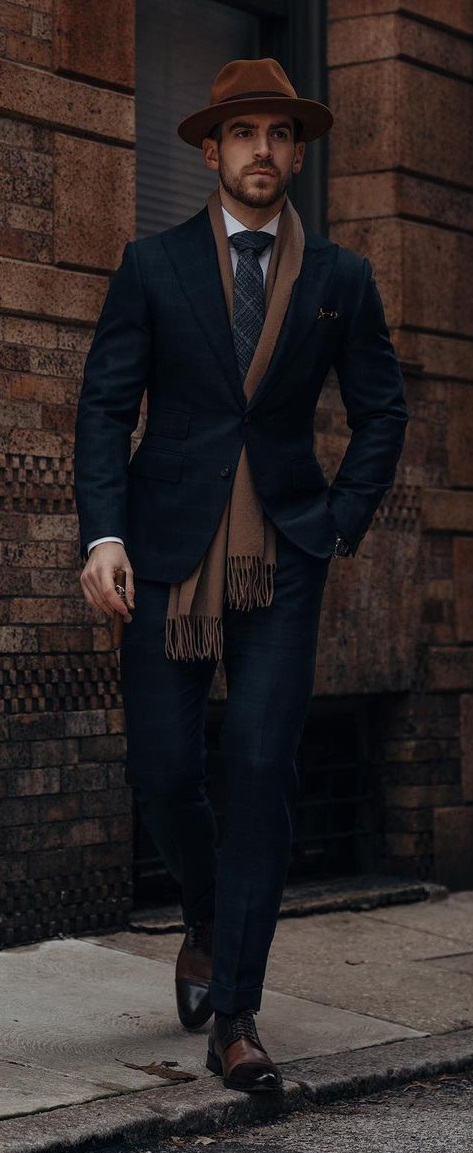 black suit with brown muffler and black boots for a smart casual outfit