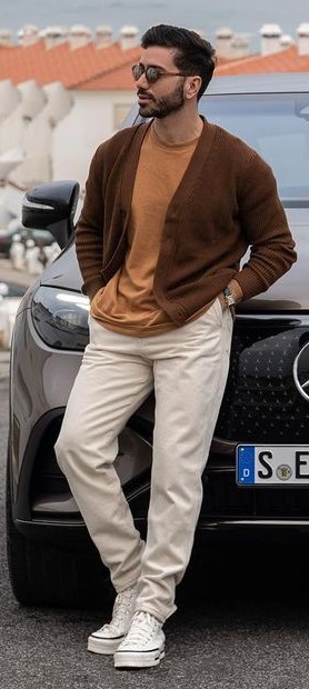 orange tshirt with brown jacket and white chinos with white sneakers and a watch for a smart casual outfit