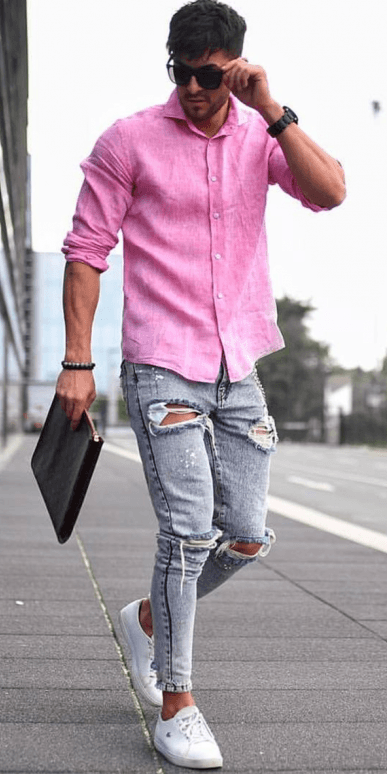 pink shirt with ripped greyish blue denims and white sneakers