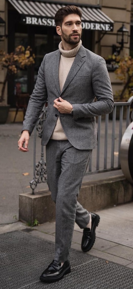 smart casual outfit with grey suit and cream turtle neck tshirt wearing boots in foot