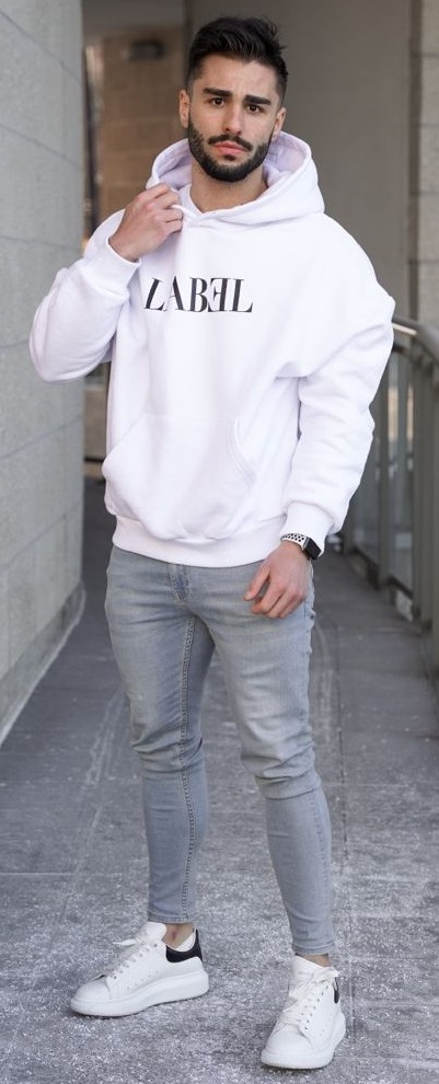 graphical hoodie in white with white sneakers and a watch