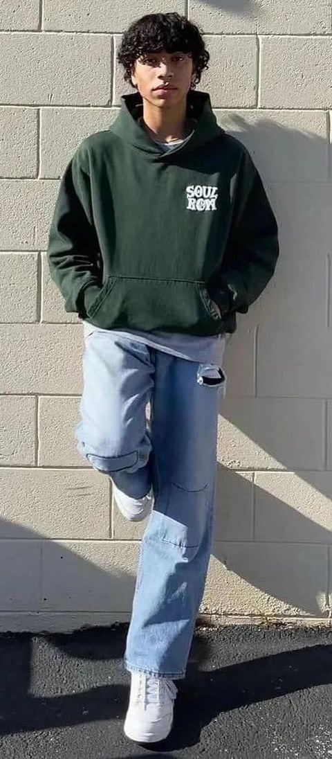 pullover hoodie in green color with blue denims and white sneakers