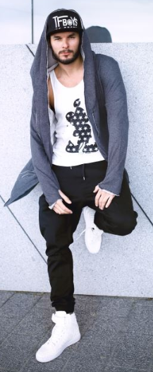 zip-up hoodie with a black jogger, and a vested top with white sneakers and a cap