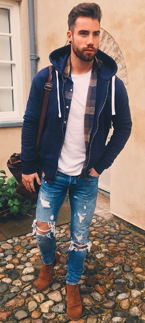 zip-up hoodie with a jacket and a ripped denims, accessorized with a shoulder bag