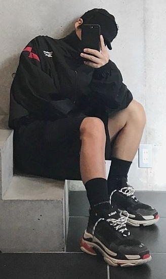 Balenciaga Triple S Sneakers with socks, with a jacket and shorts, accessorized with a cap and shorts, being one of the must-have products to own