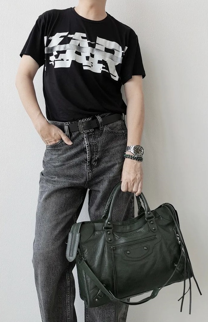 a black tshirt with a grey denims, accessorized with Balenciaga City Bag, a watch and a bracelet being must-have products to own