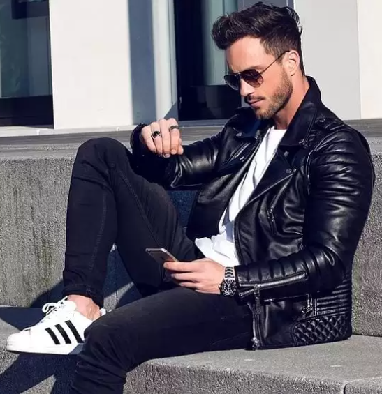 a leather jacket with a white tshirt and a black bottom with a sneaker brand adidas