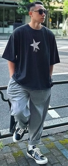 an oversized tshirt with grey bottoms and a sneaker brand - Converse