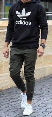 classic cargo pants in green color with black tshirt, accessorized with a watch and white sneakers