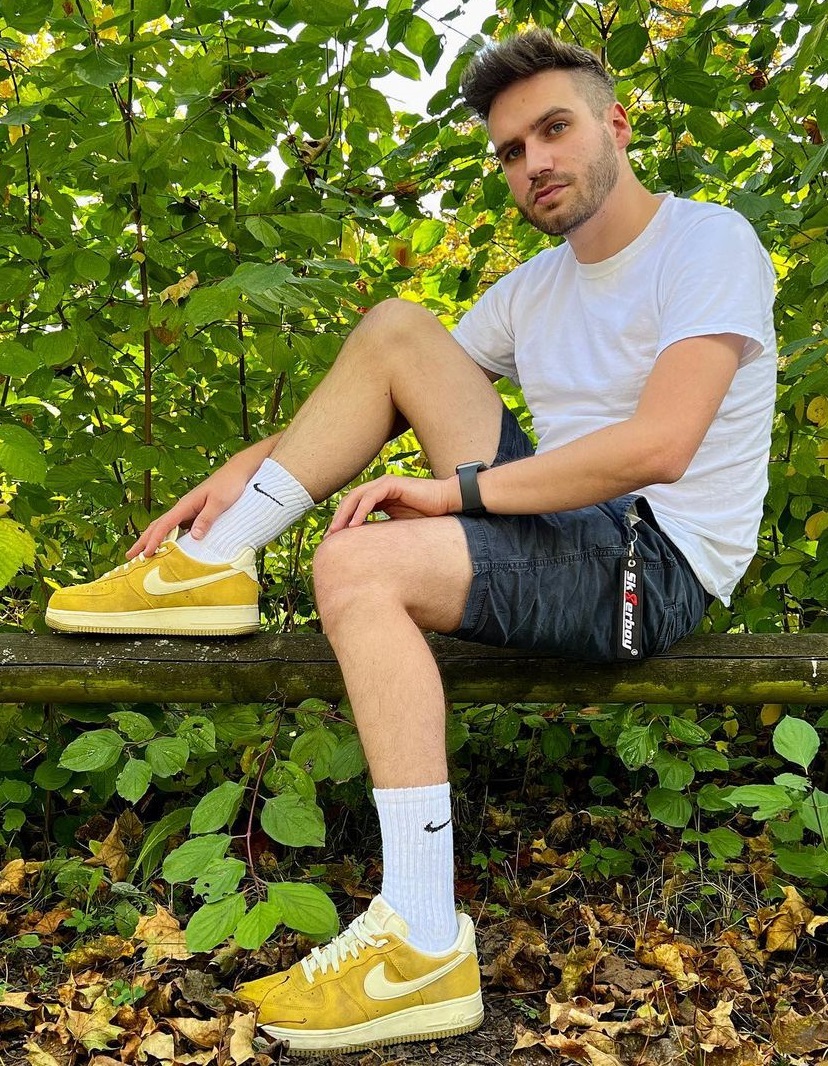 white tshirt with a shorts, sneaker brand nike and a watch