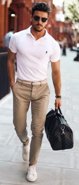 white tshirt with brown chinos accessorized with a bag and shades with sneaker